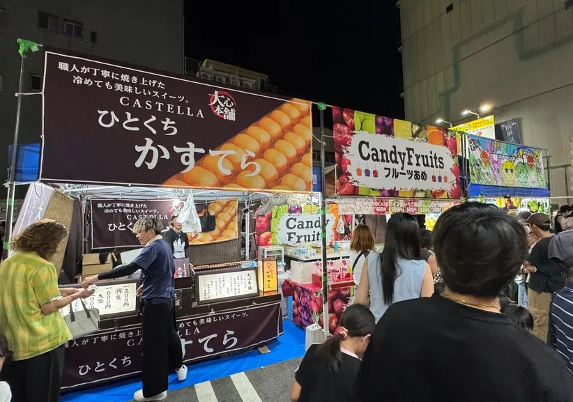 かすてらとフルーツあめの出店に来場者が並んでいる様子。
